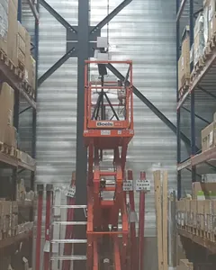Photo from a real DW WiFi survey: the battery-powered access point on a pole, raised on a scissor lift between high-bay pallet racking.