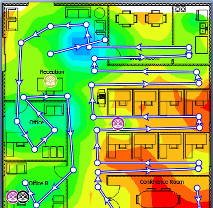Crop of a signal-level heat map over one office floor plan: blue and green where the signal is strong, red around the conference room where it is weakest, with access point icons and a route of measurement points.
